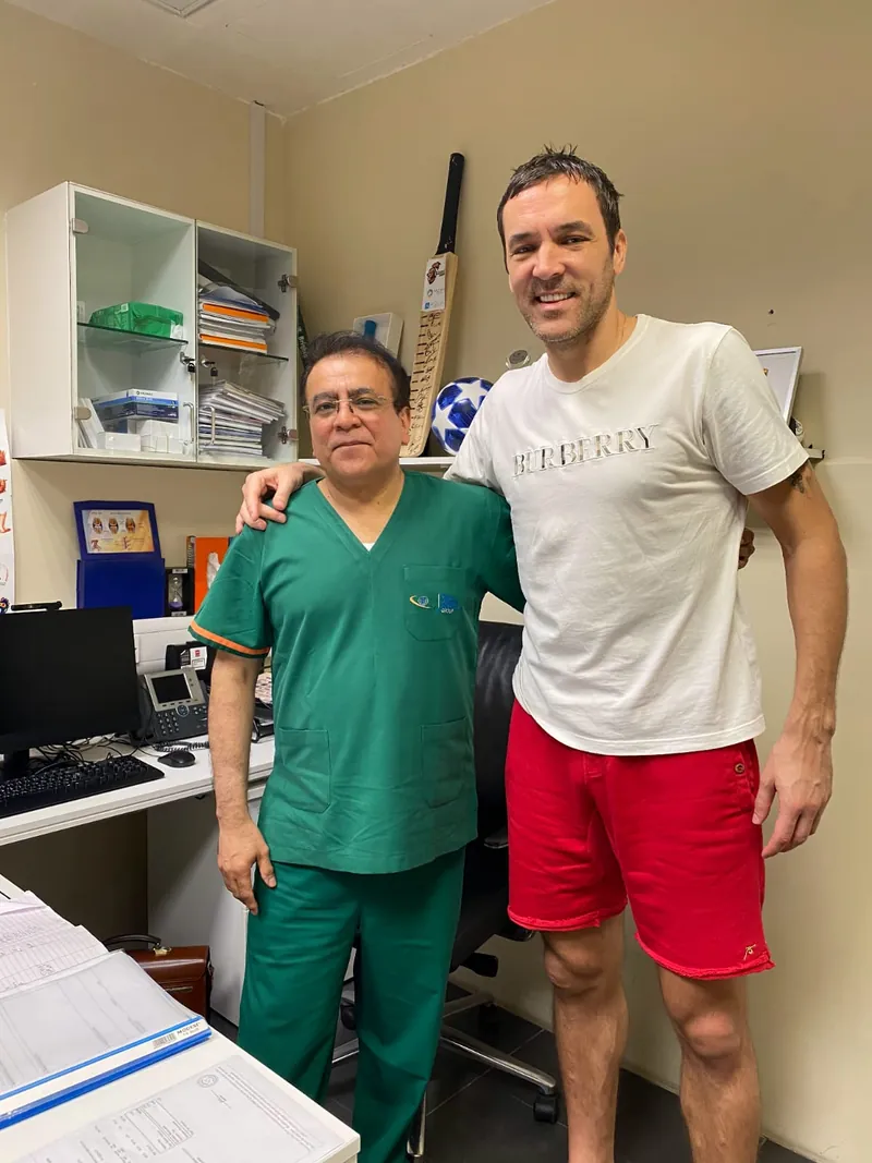 Dr. Ashfaq Konchwalla with patient in clinic